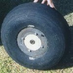 A fat tire made from a discarded Cessna 600x6 tire and a wood hub as mentioned below.